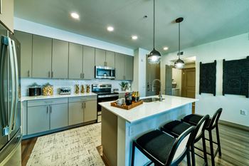 Quartz countertops with tile backsplashes